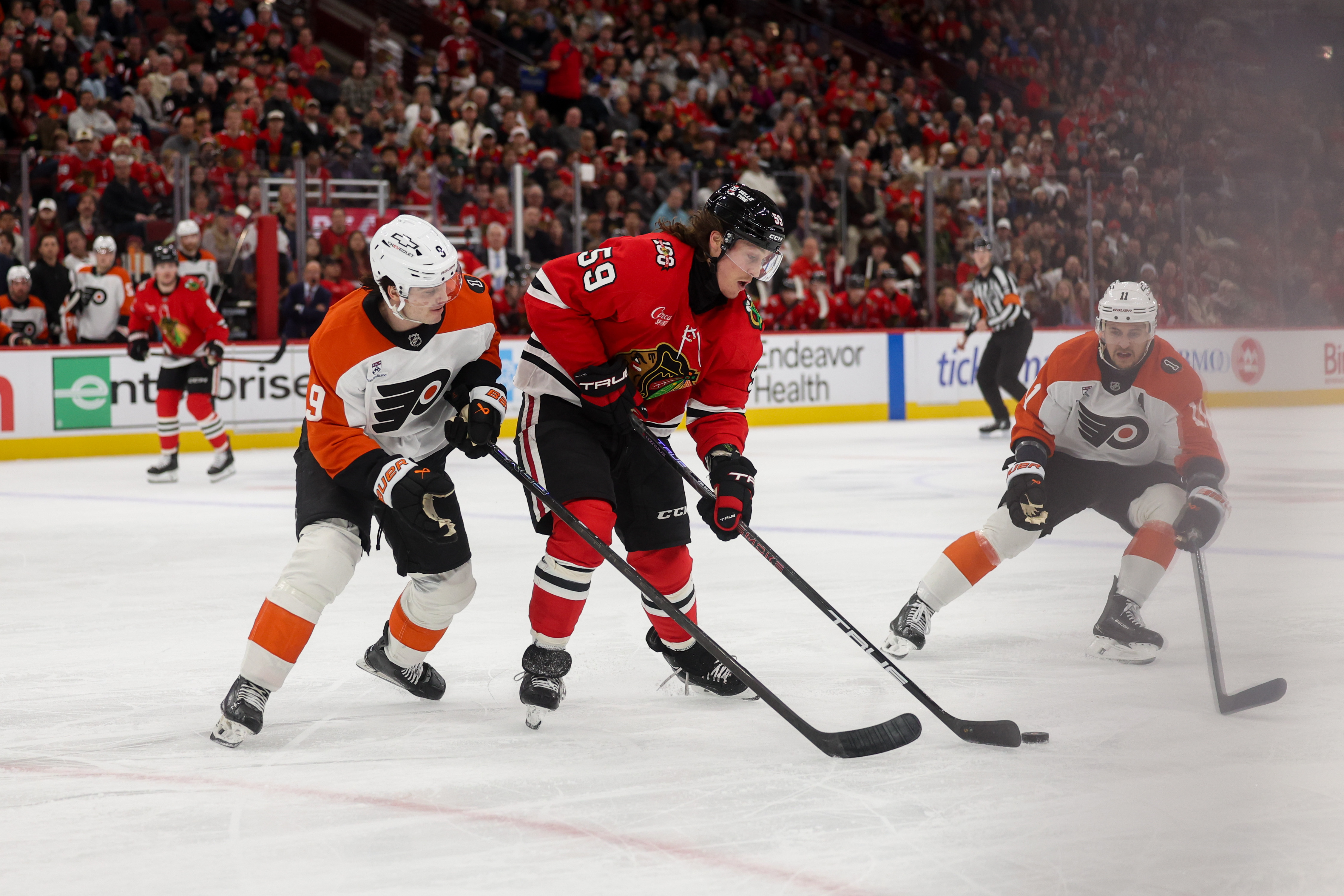 Philadelphia Flyers defenseman Jamie Drysdale (9) guards Chicago Blackhawks left wing Tyler Bertuzzi (59) while he handles the puck during the first period at the United Center Tuesday Dec. 23, 2025 in Chicago. (Armando L. Sanchez/Chicago Tribune)