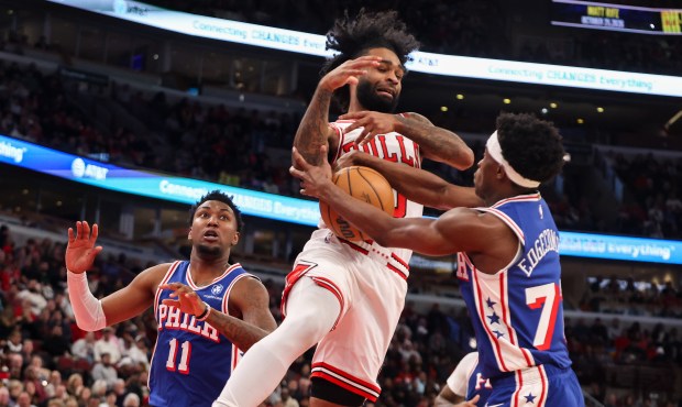 Chicago Bulls guard Coby White (0) and Philadelphia 76ers guard Vj Edgecombe (77) fumble for the ball in the second quarter, Dec. 26, 2025, at the United Center in Chicago. (Dominic Di Palermo/Chicago Tribune)