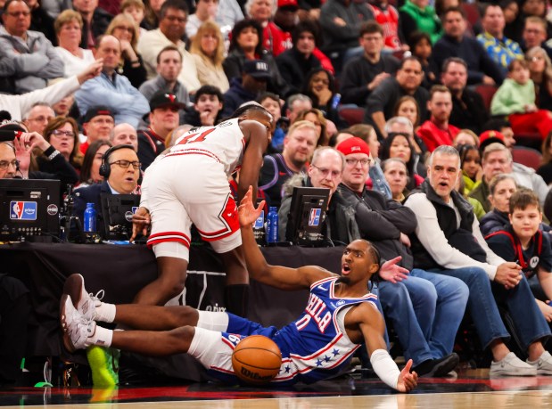 Philadelphia 76ers guard Tyrese Maxey (0) and Chicago Bulls guard Ayo Dosunmu (11) collide and a foul was called on Dosunmu in the fourth quarter, Friday, Dec. 26, 2025, at the United Center in Chicago. (Dominic Di Palermo/Chicago Tribune)