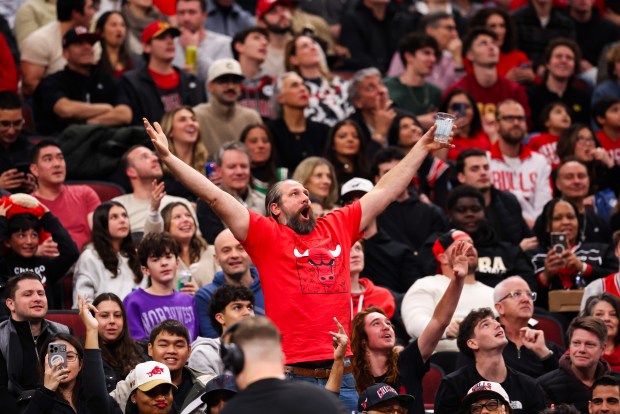 A fan cheers to get on the big screen in the third quarter during a game between the Bulls and the Philadelphia 76ers, Friday, Dec. 26, 2025, at the United Center in Chicago. (Dominic Di Palermo/Chicago Tribune)