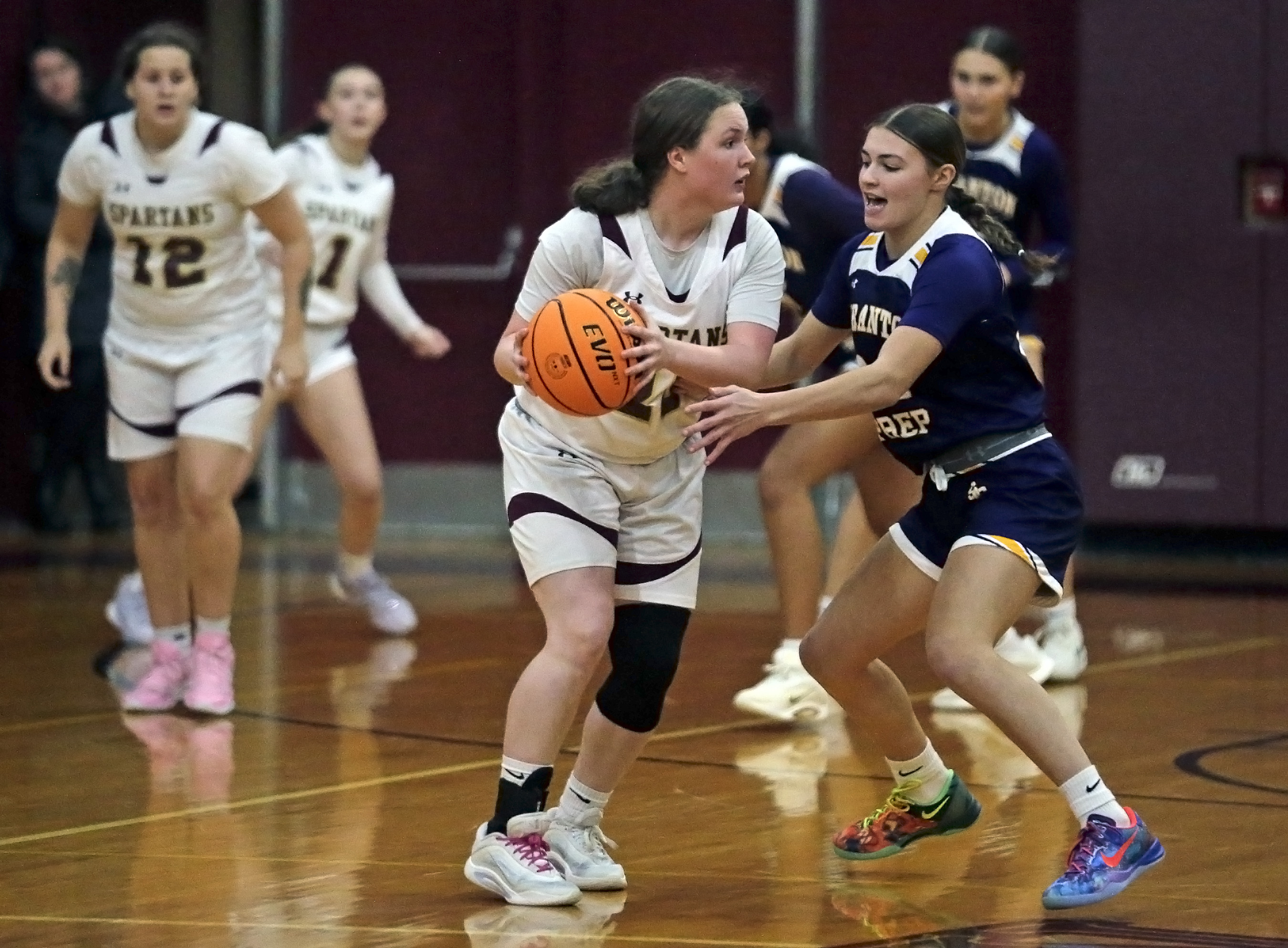 Wyoming Valley West’s Rebecca Staniecki, center, looks to pass around...