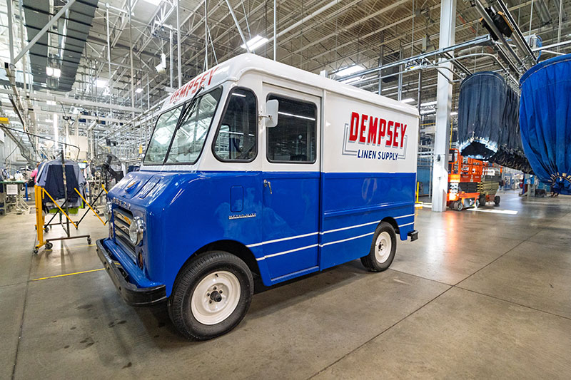 A restored antique Dempsey Uniform & Linen Supply truck on display inside the Jessup, Pennsylvania, plant.