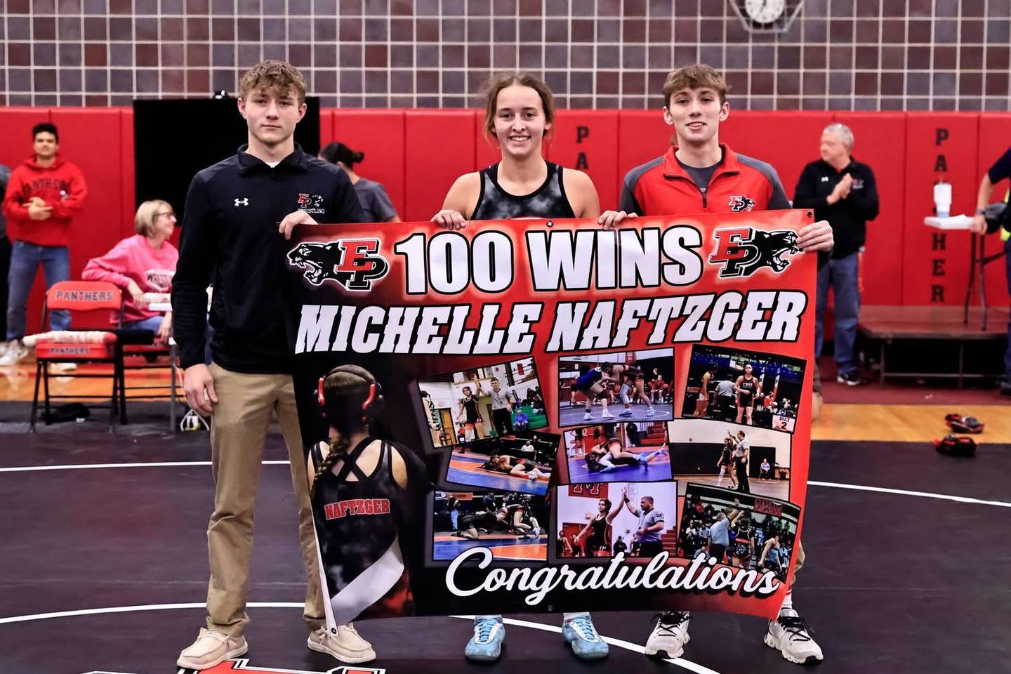 Erie-Prophetstown senior wrestler Michelle Naftzger is pictured with head coach Thad Jacobs, right, and assistant coach Tharren Jacobs. She is the Sauk Valley Athlete of the Week after becoming the first E-P girls wrestler to reach 100 career wins.
