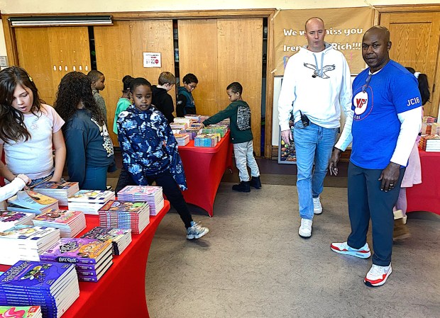 Garrettford Elementary School Principal Allen Brydges and Granson's father, David, right, direct the students. (PETE BANNAN-DAILY TIMES)