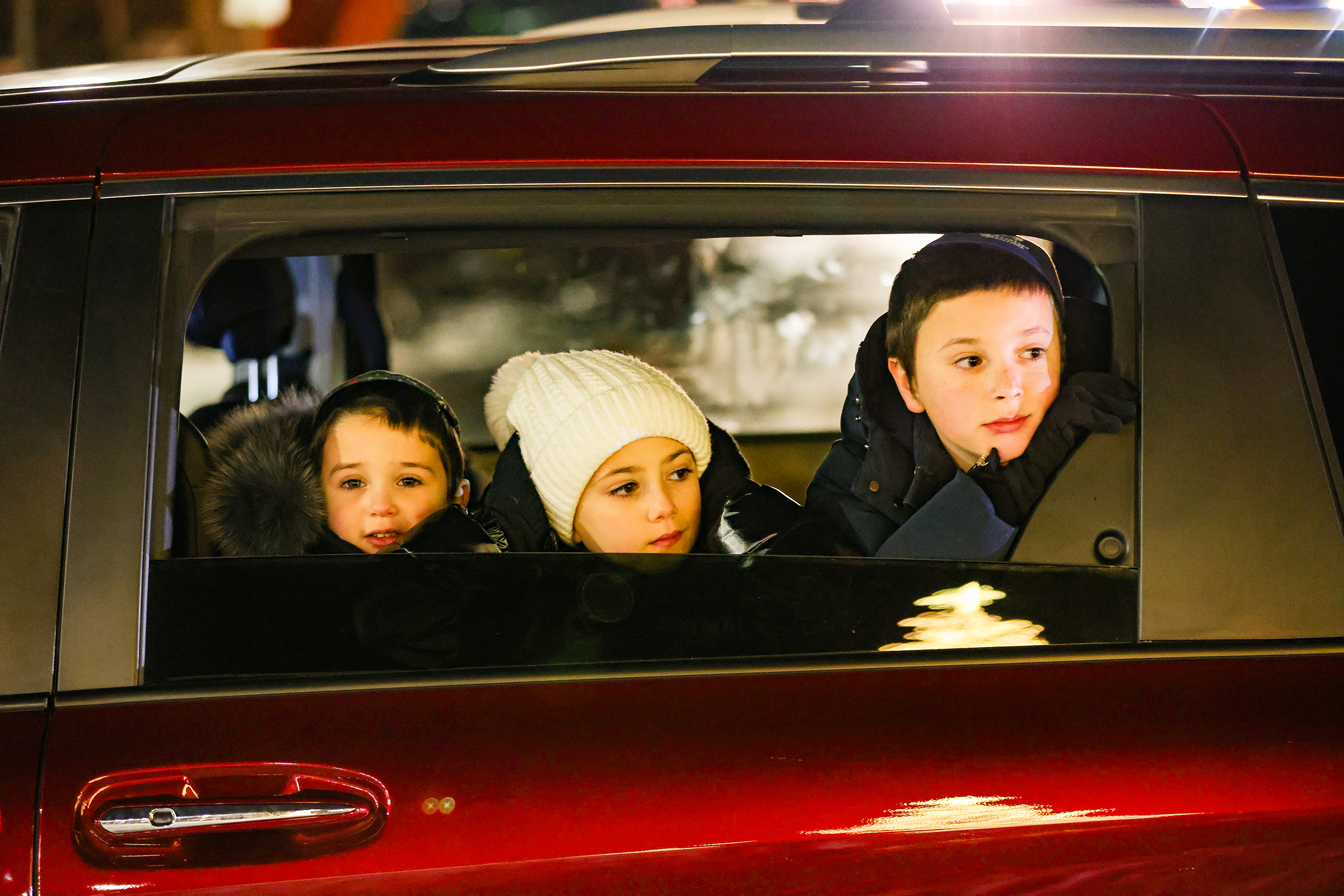 The Halperin family watches the ceremony from their car. Chabad Lubavitch of the Lehigh Valley celebrates Hanukkah with a "Lighting of Unity" public menorah lighting Monday, Dec. 15, 2025, on Payrow Plaza outside Bethlehem City Hall.
