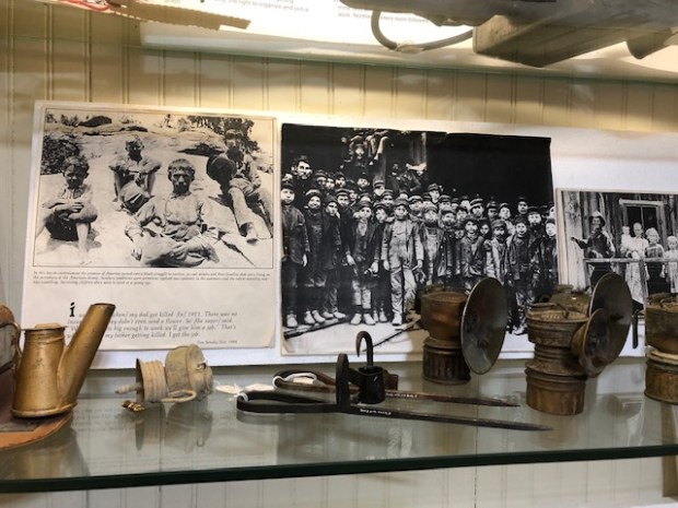 Old black-and-white photographs from Erie's early coal mining days are displayed in the Wise Homestead Museum. Boys who worked at the mines are in some of the photos. (Ed Otte/For the Greeley Tribune)