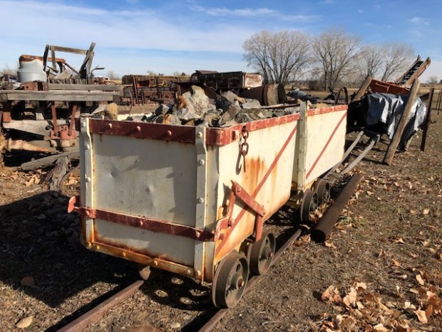 Old mining and farm equipment is displayed on the south side of a barn at the Wise Homestead Museum. (Ed Otte/For the Greeley Tribune)