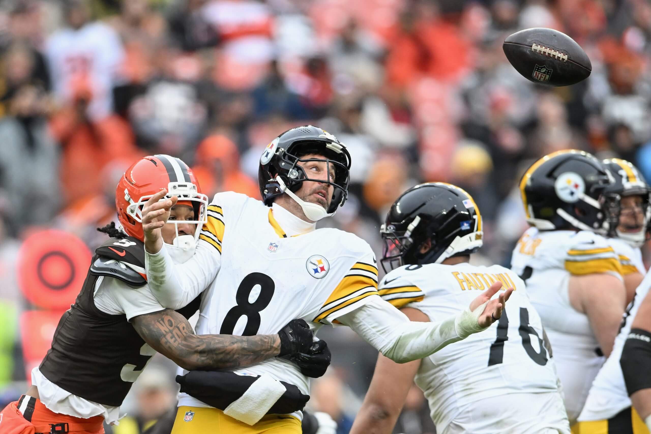 Aaron Rodgers of the Pittsburgh Steelers fumbles the ball defended by Grant Delpit of the Cleveland Browns during the third quarter at Huntington Bank Field on December 28, 2025 in Cleveland, Ohio.
