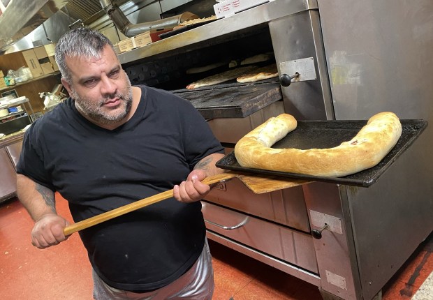 Elvis DiBlasi of Two Italian Guy Pizzeria in Hazleton removes a Stromboli from the oven on Monday, Nov. 3, 2025. The pizzeria is moving to Freeland and will be called Nonno Cicci's. (John Haeger / Staff Photographer)