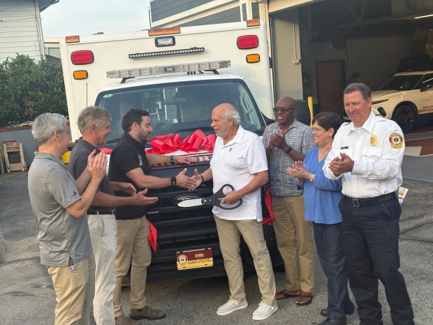 From left to right Lower Merion Commissioners Andy Gavrin and Scott Zelov; Michael Brafman, president of Narberth Ambulance shaking hands with Lower Merion Commissioner Louis Rossman; commissioners Anthony Stevenson and Gilda Kramer. To the right is John Mick, chief of operations for Narberth Ambulance. (Photo Richard Ilgenfritz MediaNews Group)