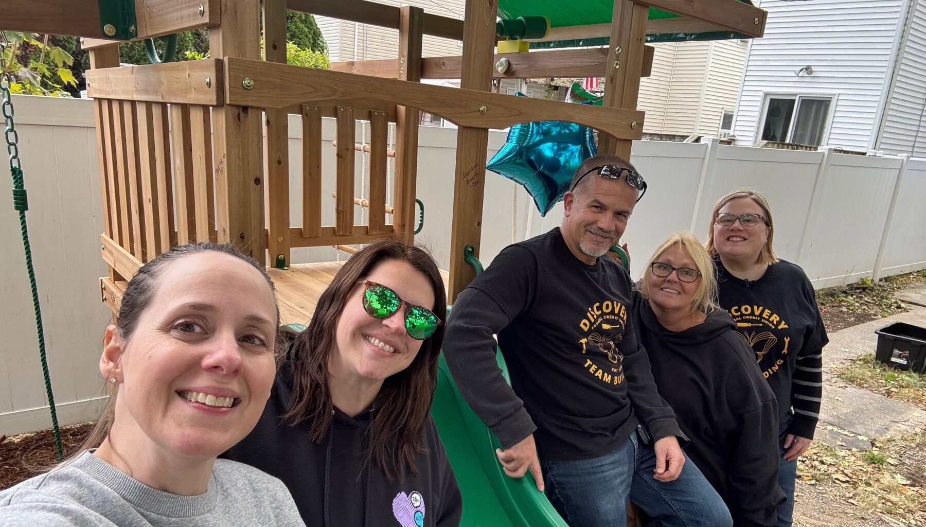The Discovery FCU team builds a playset for a local child fighting cancer