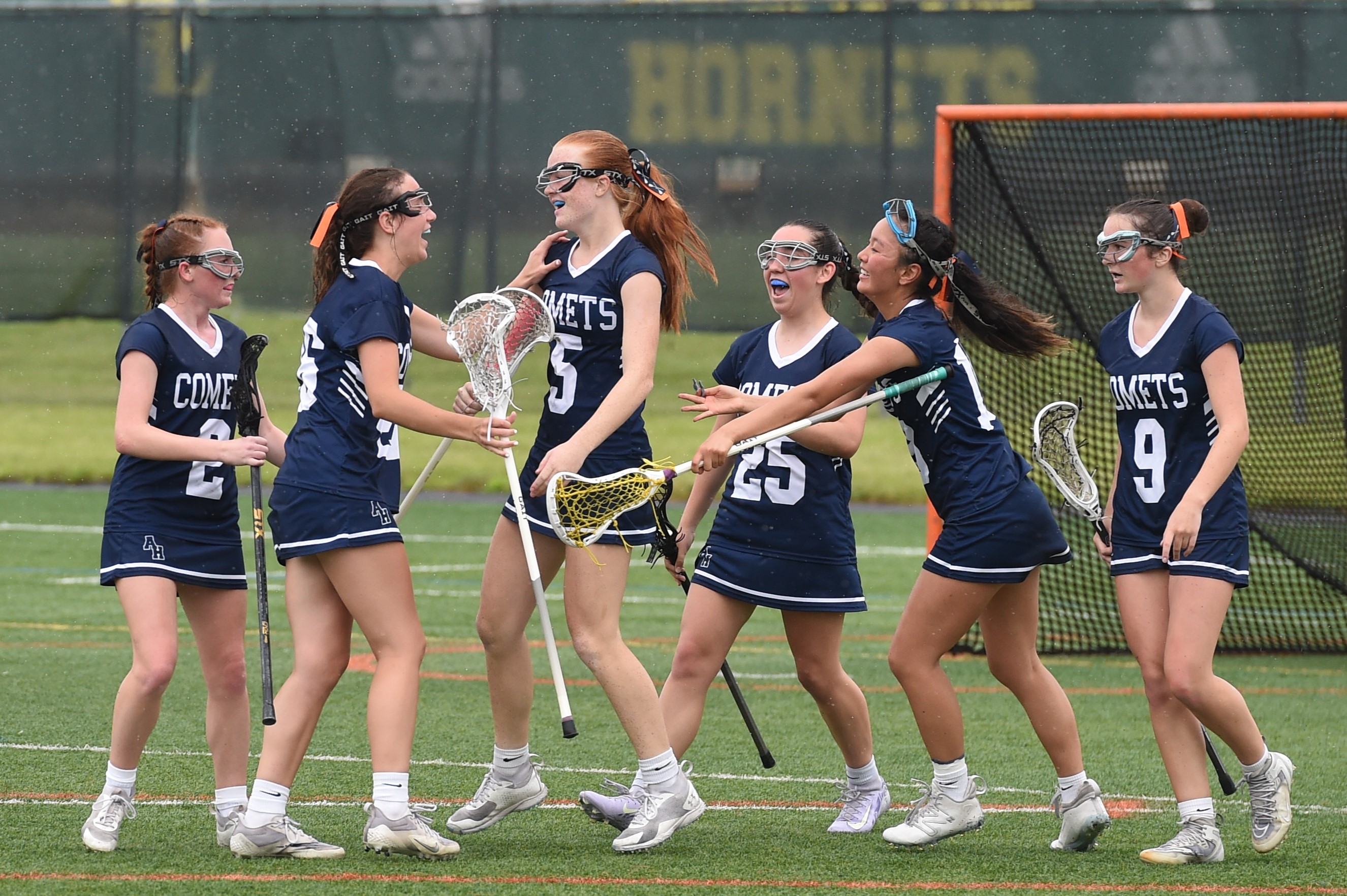 Abington Heights’ Morgan Davis, 5, is congratulated by teammates after...