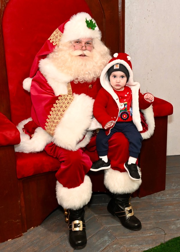 Kaiden Banyai, 15 months, visits with Santa at Christmas in Birdsboro on Dec. 13. (Jesi Yost/For MediaNews Group)
