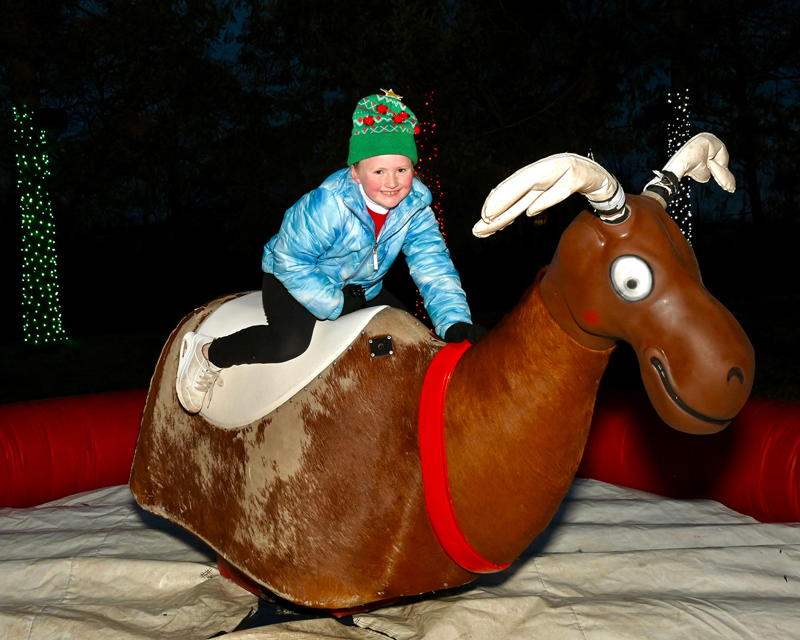 Evelyn Acevedo, 6, of Birdsboro rides a mechanical reindeer during...