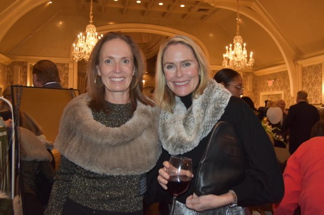 Quincy McCoy and Jennifer Bowers enjoy modeling furry shawls from...