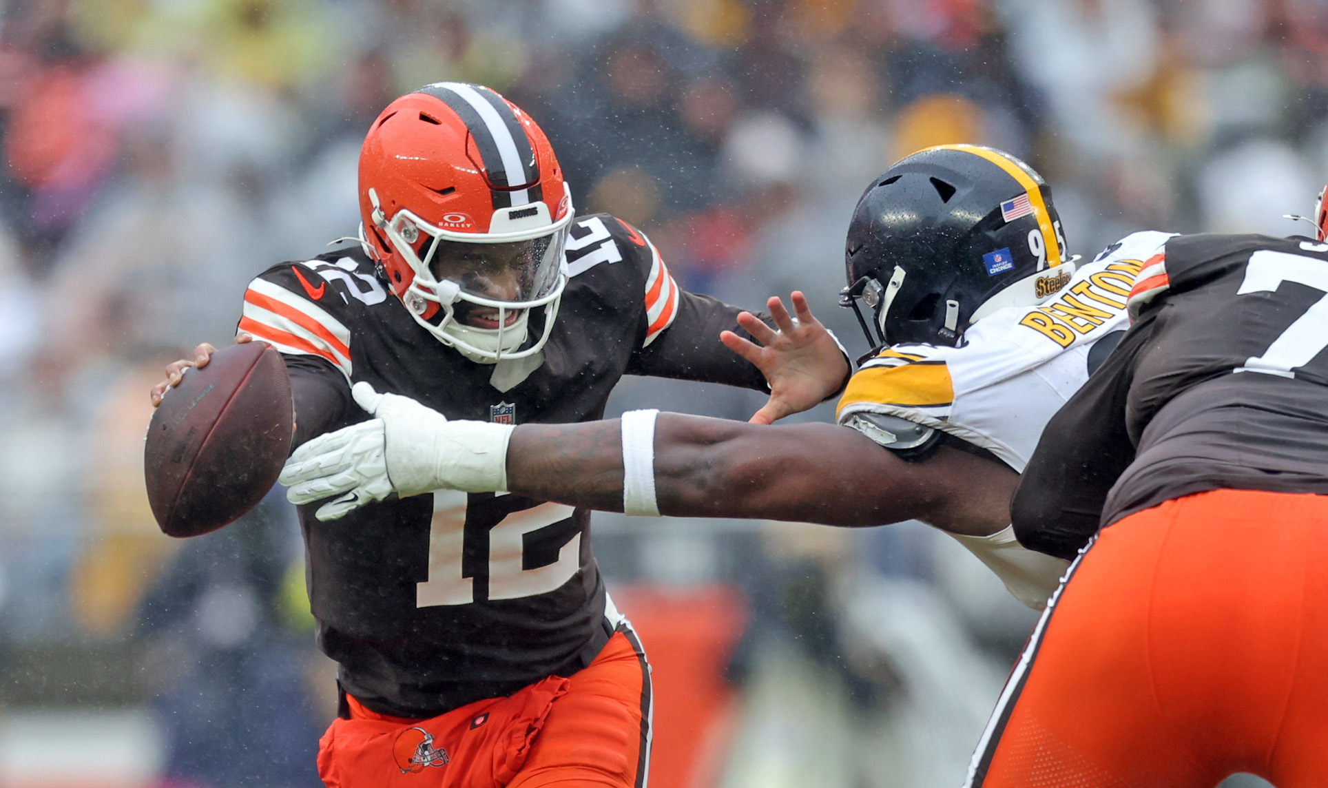 Cleveland Browns quarterback Shedeur Sanders evades Pittsburgh Steelers defensive tackle Keeanu Benton in the first half of play. 