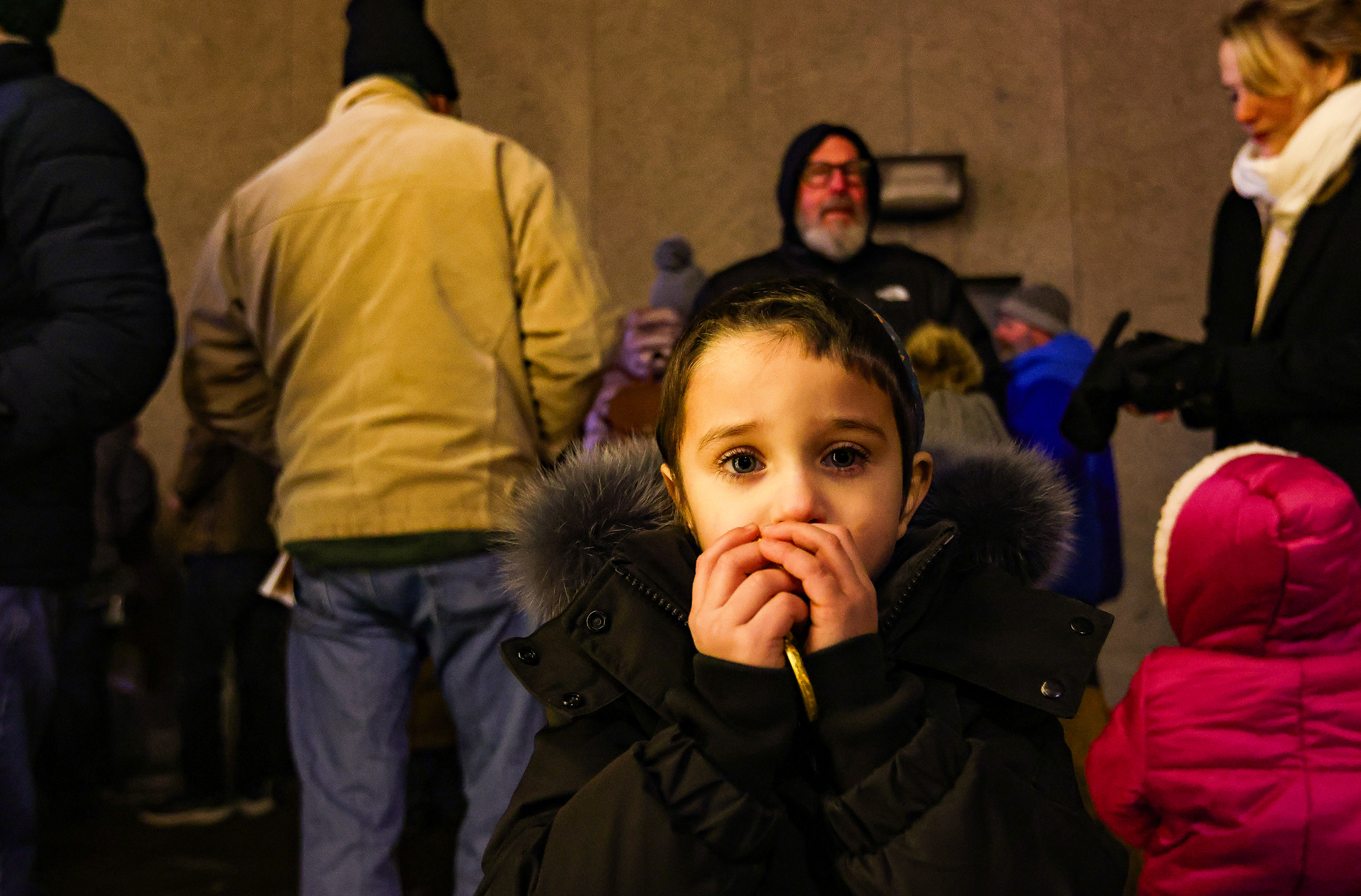 Aryah Greenberg, 3, of Bethlehem, catches chocolate coins at the public menorah lighting Monday, Dec. 15, 2025, on Payrow Plaza outside Bethlehem City Hall.