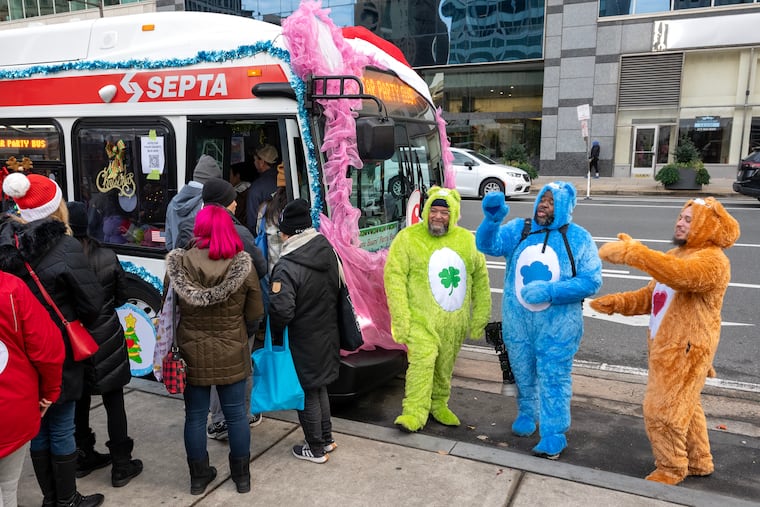 SEPTA operators costumed as Care Bears (from left) Jose DeCos and James Smith; and mechanic Raymond Borges greet visitors during the weekend’s Festibus Competition Saturday, Dec. 6, 2025.