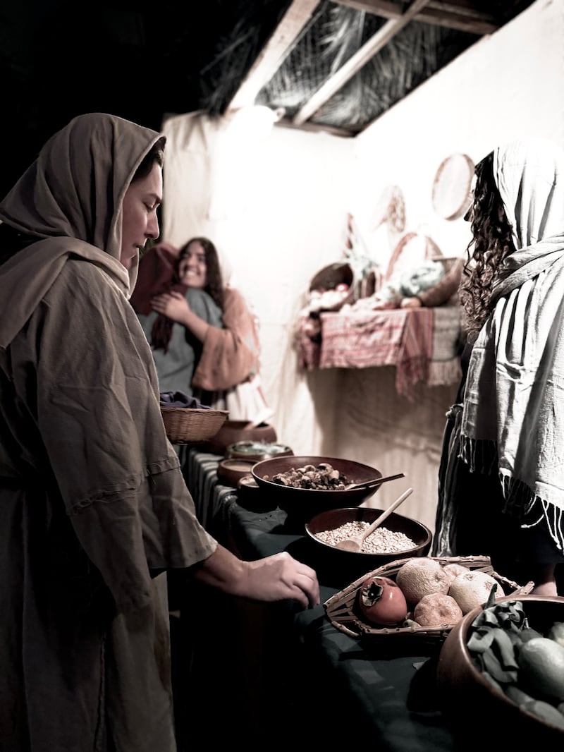 A volunteer runs a food station in the Bethlehem Walk of Escondido, which ran Dec. 12-14, 2025, at the Escondido California Stake Center.