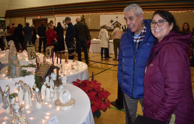 Victor and Adriana Puente admiring the nativity scenes. (Elizabeth Marie Himchak)