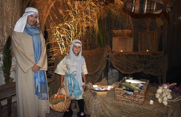 Kim Rodriguez and her daughter, Clara, portraying sellers in the Bethlehem Village fish market. (Elizabeth Marie Himchak)