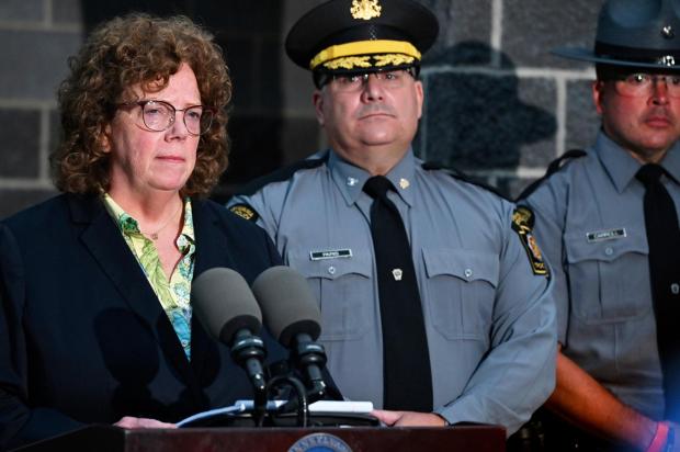 Susquehanna County District Attorney Marion O'Malley and Pennsylvania State Police Col. Christopher L. Paris answer questions about the Pennsylvania state trooper ambush. (AP Photo/Aimee Dilger)