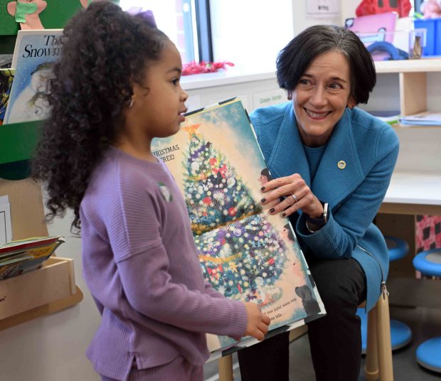 Three-year-old Cayla helps state Department of Human Services Secretary Dr. Val Arkoosh as she reads to children at the Patton Avenue Learning Center in Oakbrook on Thursday, Dec. 11, 2025. (BILL UHRICH/READING EAGLE)