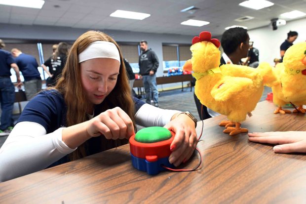 Claire Costa, 21, of New Tripoli, Lehigh County, and a third-year student at Penn State Berks, assembles an adapted pushbutton during the Berks County Intermediate Unit's Toy Adaptation Day at the BCIU main office, 111 Commons Blvd., Muhlenberg Township, on Friday, Dec. 5, 2025. (BILL UHRICH/READING EAGLE)