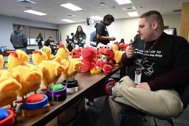 Aedan Jobes, 19, of Birdsboro, looks over completed toys during the Berks County Intermediate Unit's Toy Adaptation Day at the BCIU main office, 111 Commons Blvd., Muhlenberg Township, on Friday, Dec. 5, 2025. (BILL UHRICH/READING EAGLE)