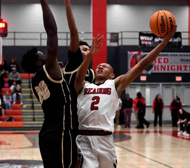 Reading High's Cameron Jones drives against Berks Catholic on his way to seven points in a 48-40 Red Knight victory over the Saints on Monday, Dec. 29, 2025, at the Geigle. (BILL UHRICH/READING EAGLE)
