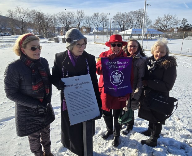 Theresa Adams, historian for Upsilon Zeta chapter of Sigma Theta Tau International Honor Society of Nursing at Alvernia University, second from left, and other members of the society pose with a historical marker in City Park paying tribute to the work of the Ladies Volunteer Aid Association of Reading during the Civil War. (KAREN SHUEY - READING EAGLE)