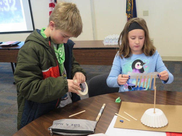Muhlenberg Elementary Center fifth grader Luke Mohler and fourth grader Kinsley Kline, work on their project during the Keystone STEM Competition at the Berks County Intermediate Unit on Tuesday. (DAVID MEKEEL - READING EAGLE)