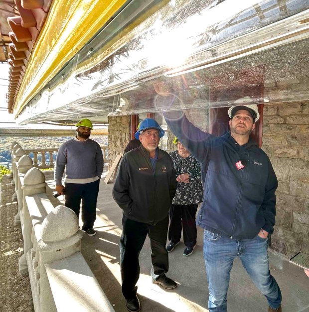 During an October tour highlighting restoration work at the Pagoda, David Anspach, city projects manager, points out the new LED exterior lighting that will flash to signal the arrival of Santa on Christmas Eve. (BILL UHRICH/READING EAGLE)