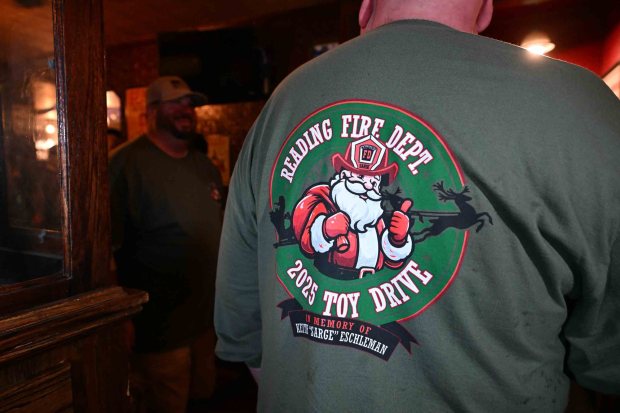 Reading Fire Chief James G. Stoudt Jr. wears a fundraising T-shirt in memory of firefighter Keith Eschleman during the department's annual Toy Drive Breakfast at Trooper Thorn's Irish Beef House, 451 Morgantown Road, on Friday, Dec. 19, 2025. . (BILL UHRICH/READING EAGLE)