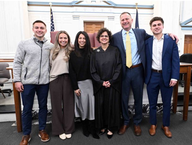 Berks County Coroner Matthew J. Stitzel, second from right, and his wife Rebecca, third from left, flank Eleni V. Dimitriou-Geishauser, a Berks County Court judge and family friend, along with the couple's children Jacob, Sarah and Matt following a swearing-in ceremony at the courthouse on Tuesday, Dec. 30, 2025.