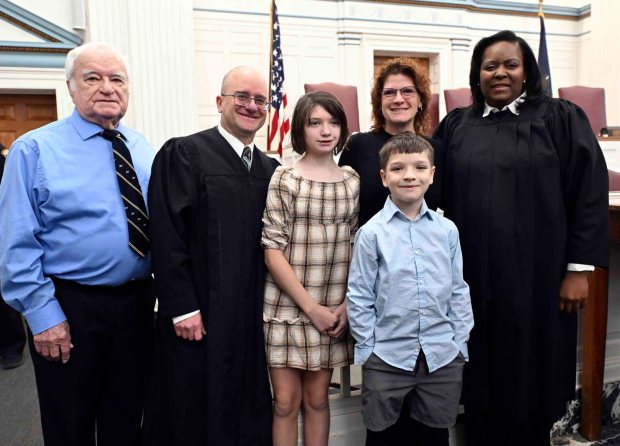 Berks County Court Judge Eric J. Taylor stands with his wife, Terrie, and children Saoirse, 12, and Deaglan, 10, along with his father ,Tom, and District Judge Carissa L. Johnson following a swearing-in ceremony at the courthouse on Tuesday, Dec. 30, 2025.