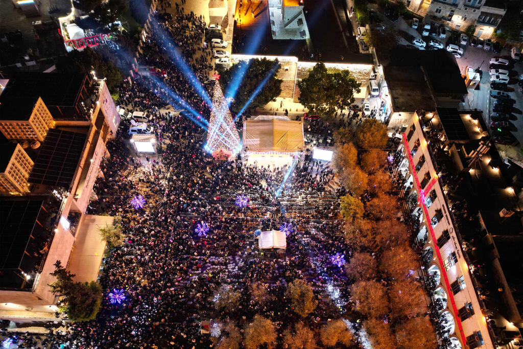 An aerial photograph shows people gathering in Nativity Square during a Christmas tree lighting ceremony in Bethlehem, West Bank, on December 6, 2025 