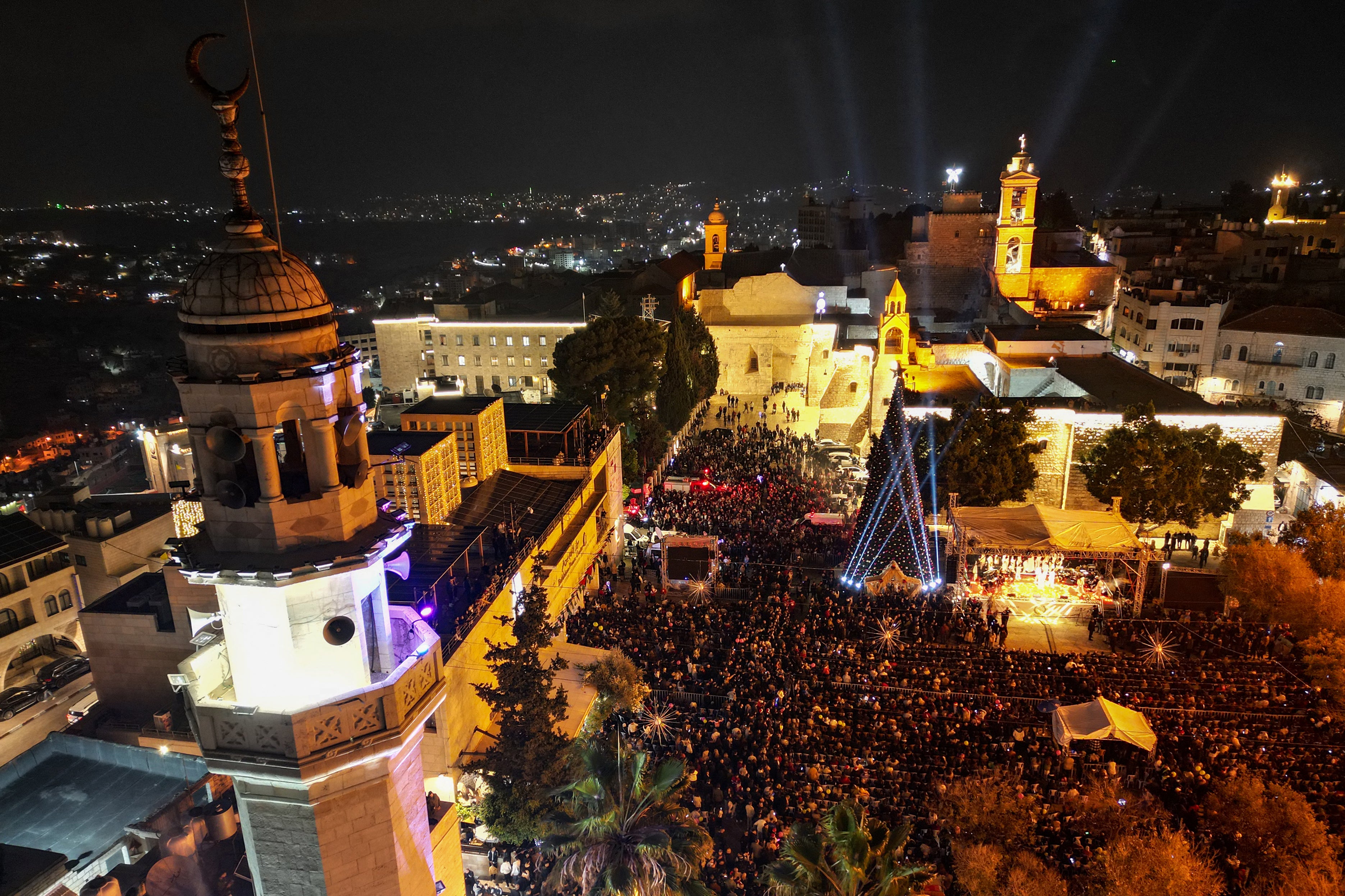 Thousands of Palestinians from across the West Bank and Israel filled the square, erupting in cheers when the tree's lights were turned on