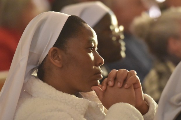 A parishioner kneels in the pews of St. Peter's Cathedral in Scranton during the Christmas Eve Pontifical Mass Wednesday, December 24, 2025. (SEAN MCKEAG / STAFF PHOTOGRAPHER)