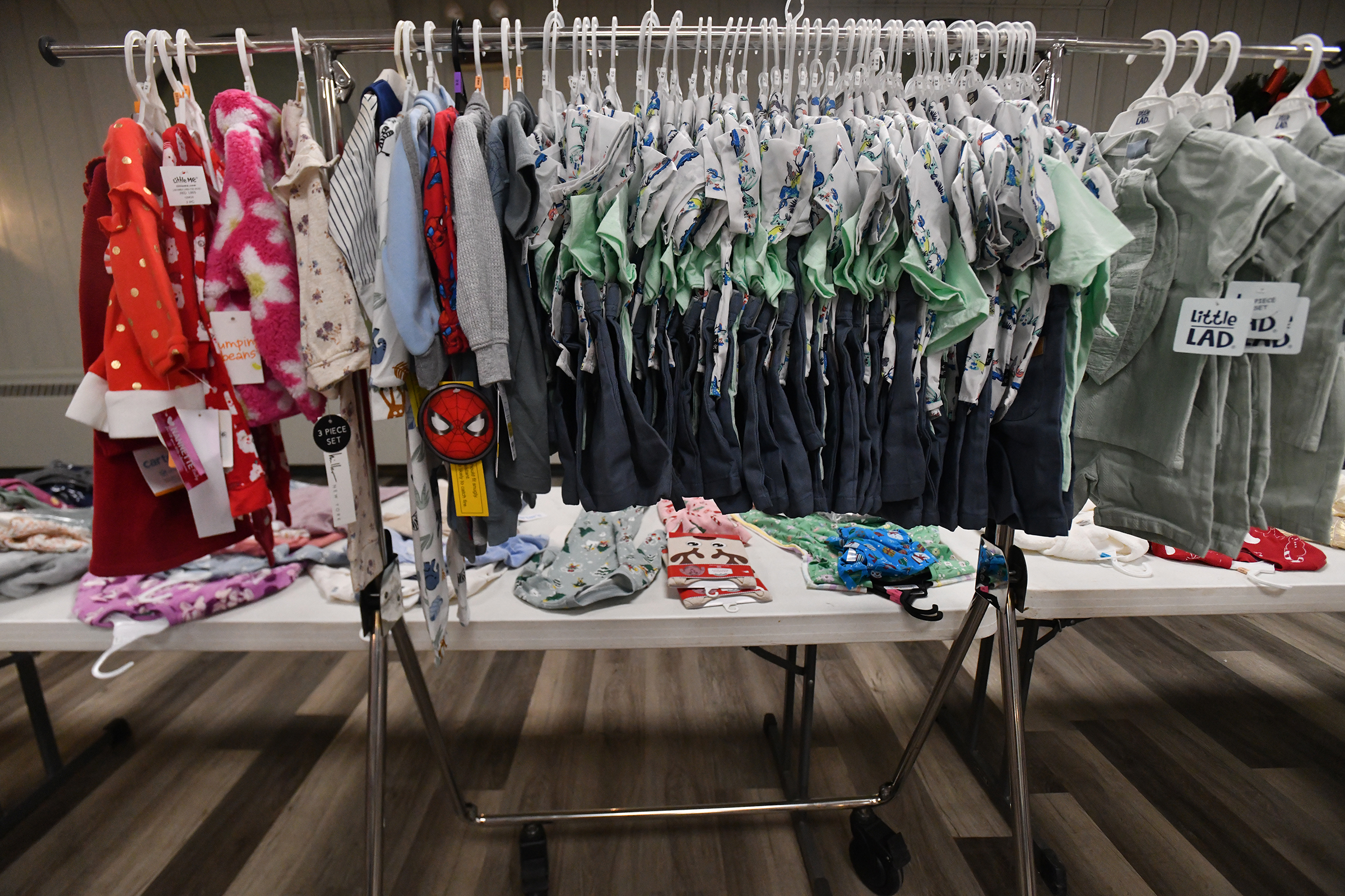 Childrens’ clothes are put out during the gift distribution at...