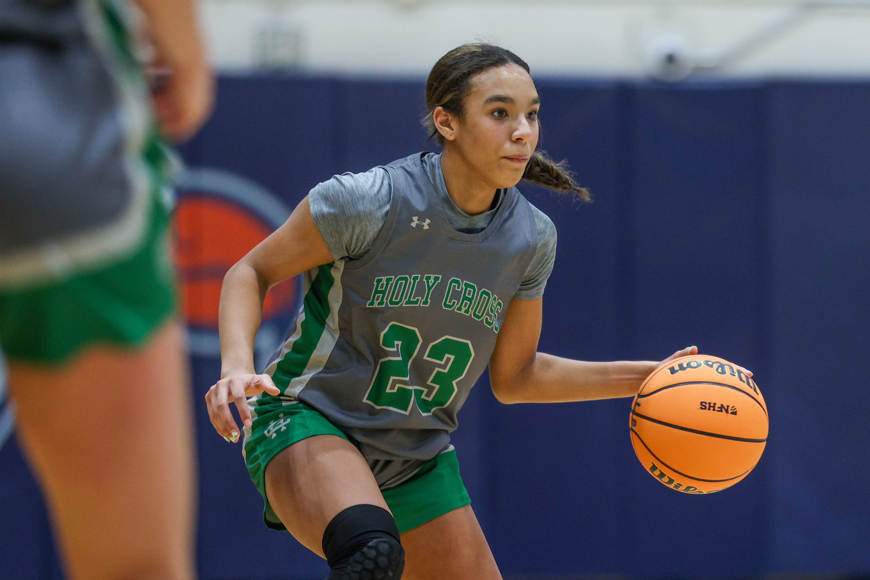 Holy Cross’ Aniya Osgood (23) handles the ball during the...