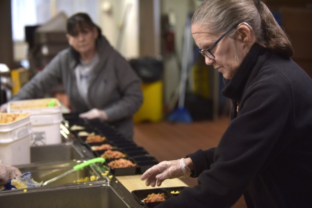 Susan Mulholland assembles meals at Meals on Wheels on Wyoming Avenue on Scranton on Monday, Dec. 22, 2025. (.CHAD SEBRING/STAFF PHOTO)