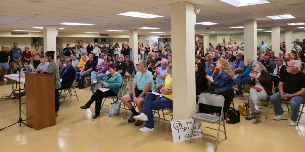 Archbald resident Tamara Misewicz-Healey, standing at podium, addresses borough council during a data center zoning hearing at St. Thomas Aquinas Church, Archbald, on Monday, Sept. 29, 2025. (FRANK WILKES LESNEFSKY / STAFF PHOTO)