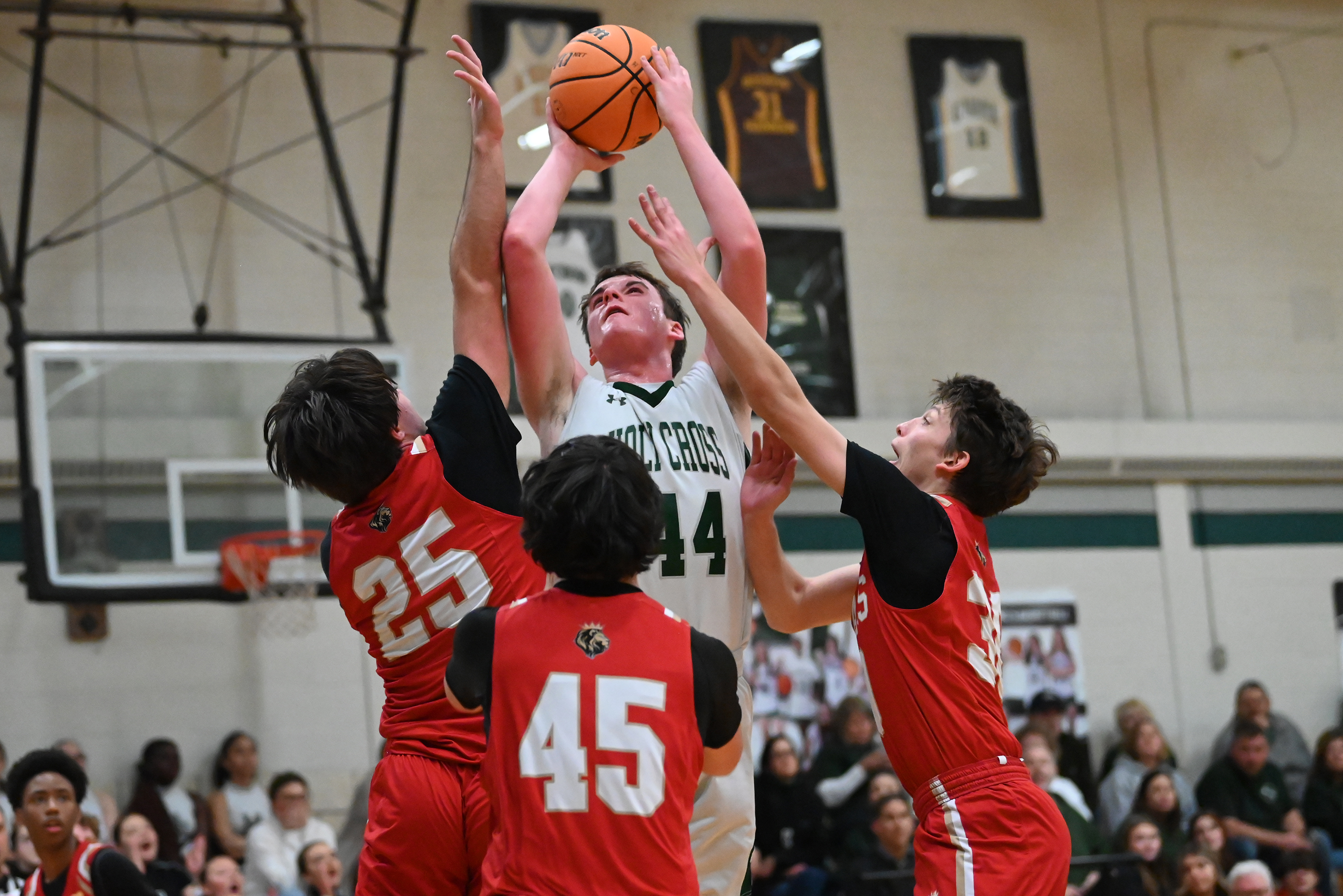 Holy Cross’ Colin Rittenbusch attempts to make a basket during...