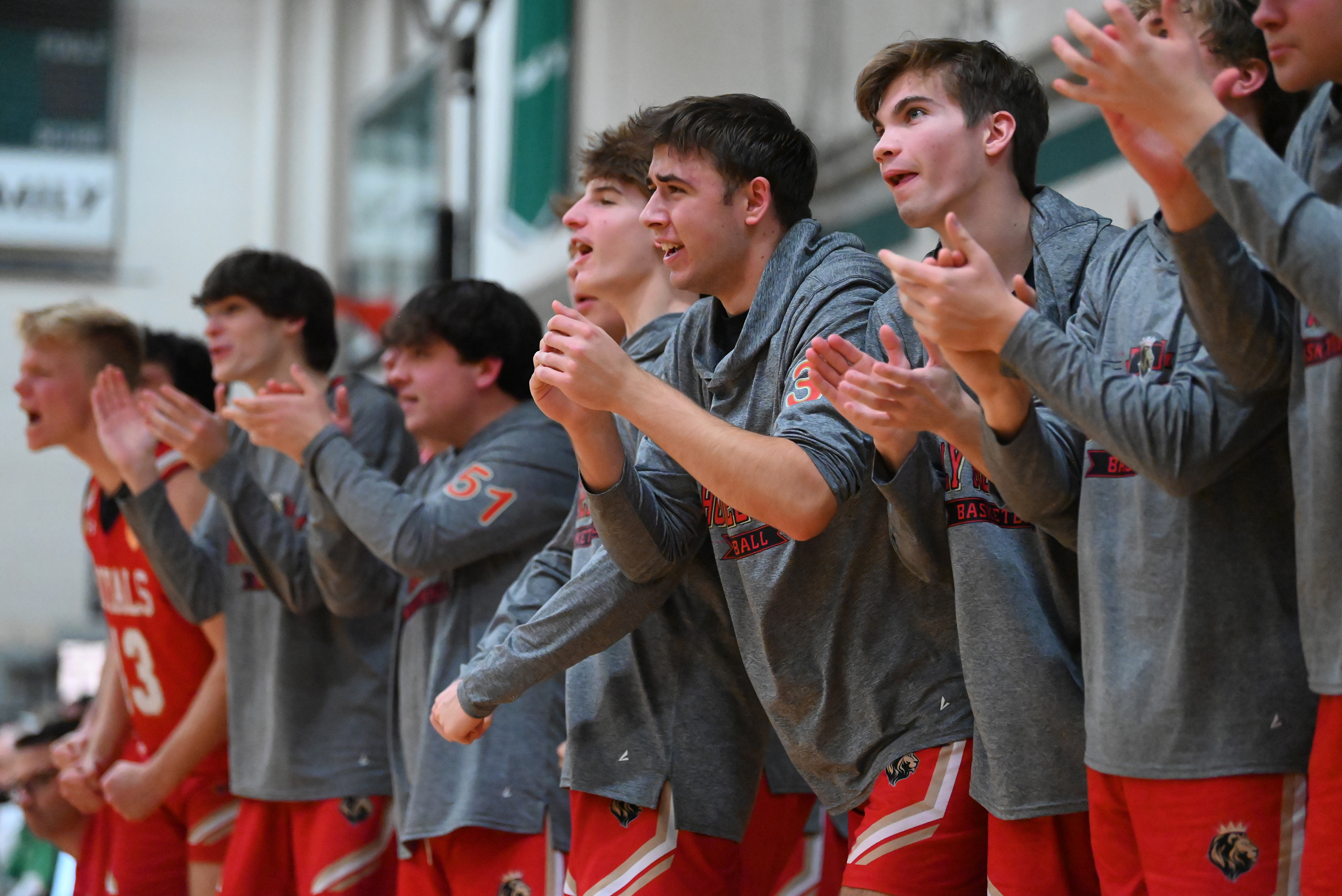 Holy Redeemer players on the bench cheer on their teammates...