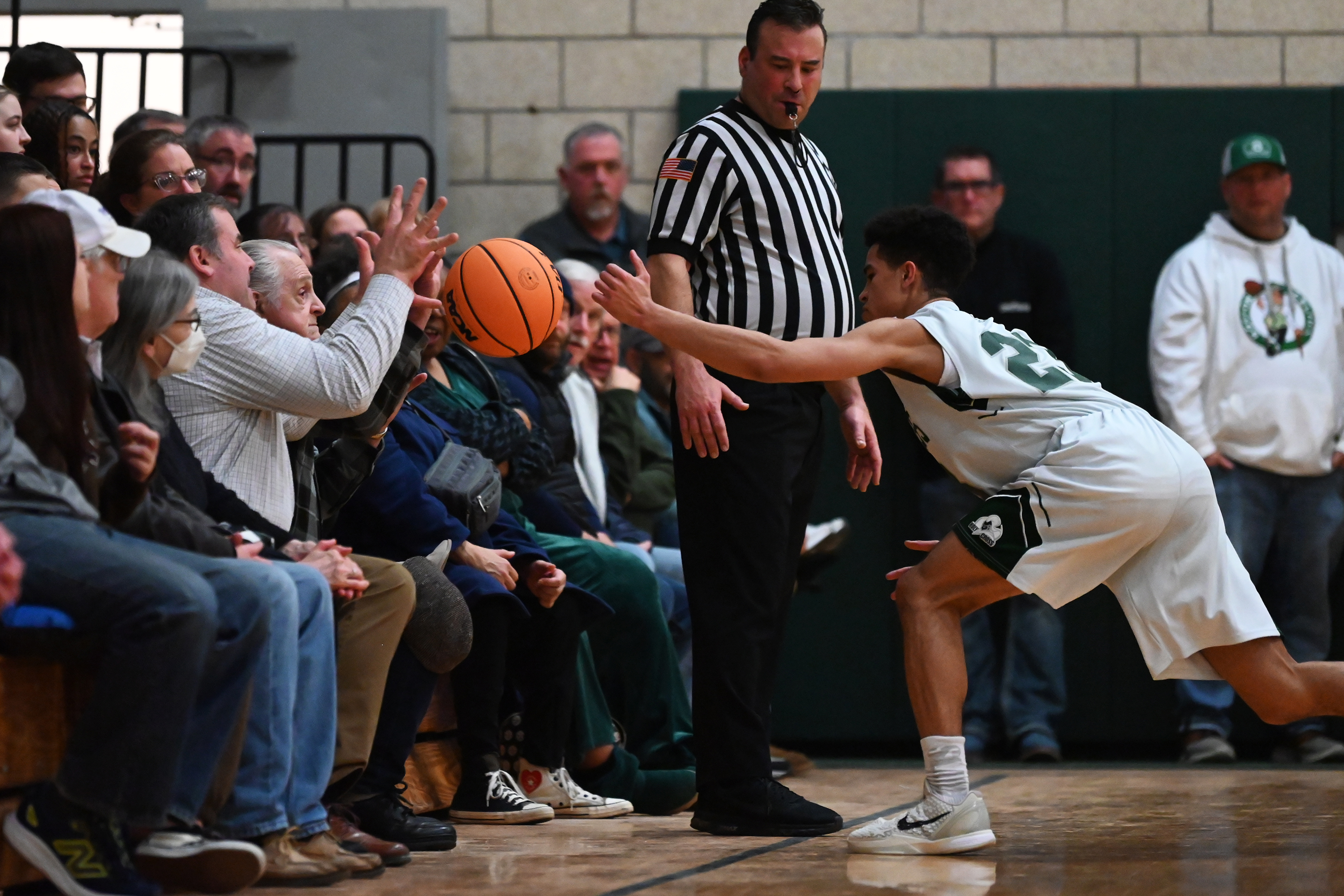 Holy Cross’ CJ Thompson attempts to keep the ball inbounds...