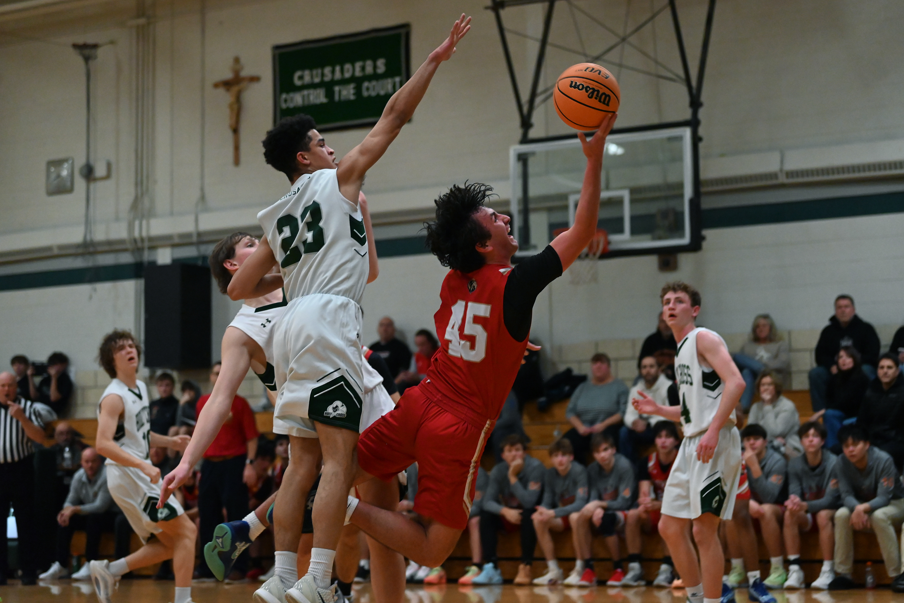 Holy Redeemer’s Logan Shrader lifts the ball to the hoop...