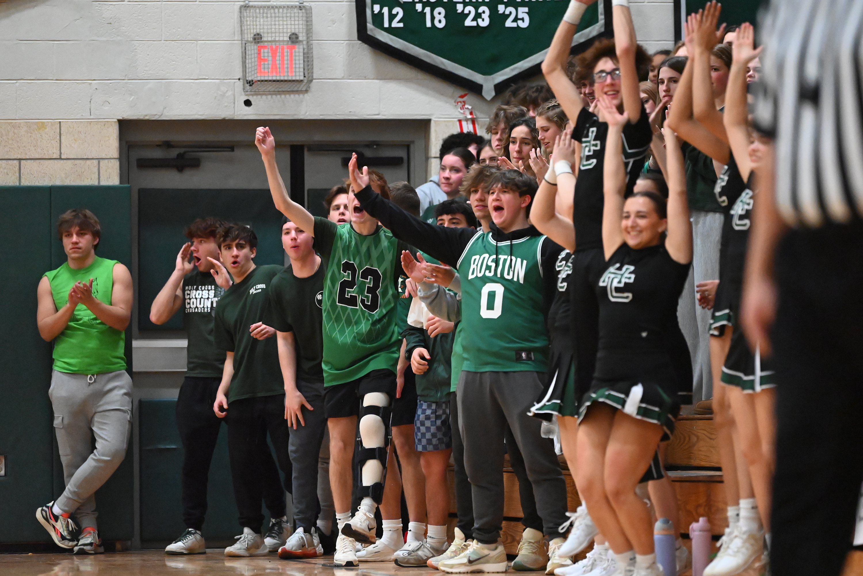 Holy Cross students and cheerleaders cheer on their team during...