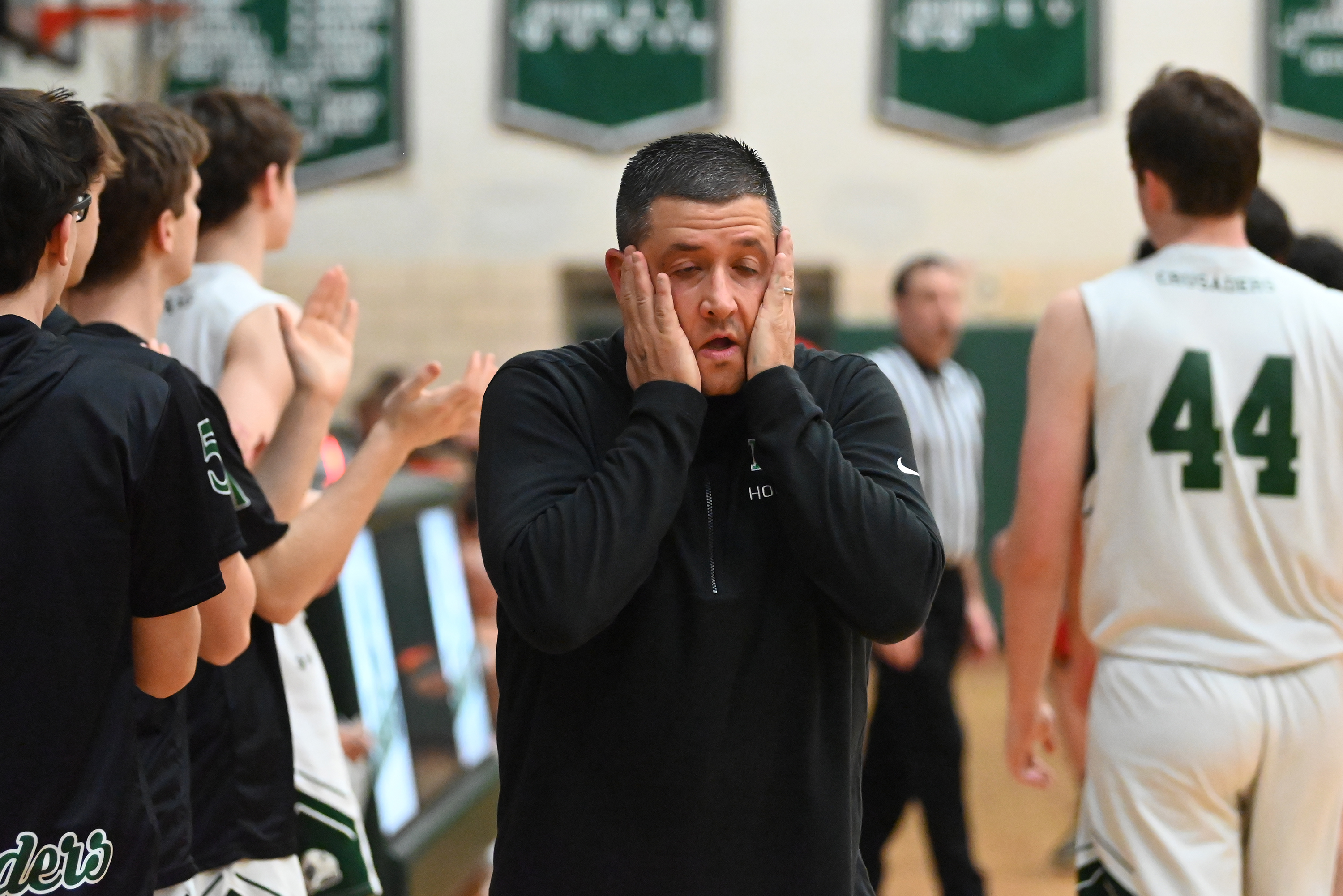 Holy Cross’ head coach Al Callejas Jr. takes a deep...