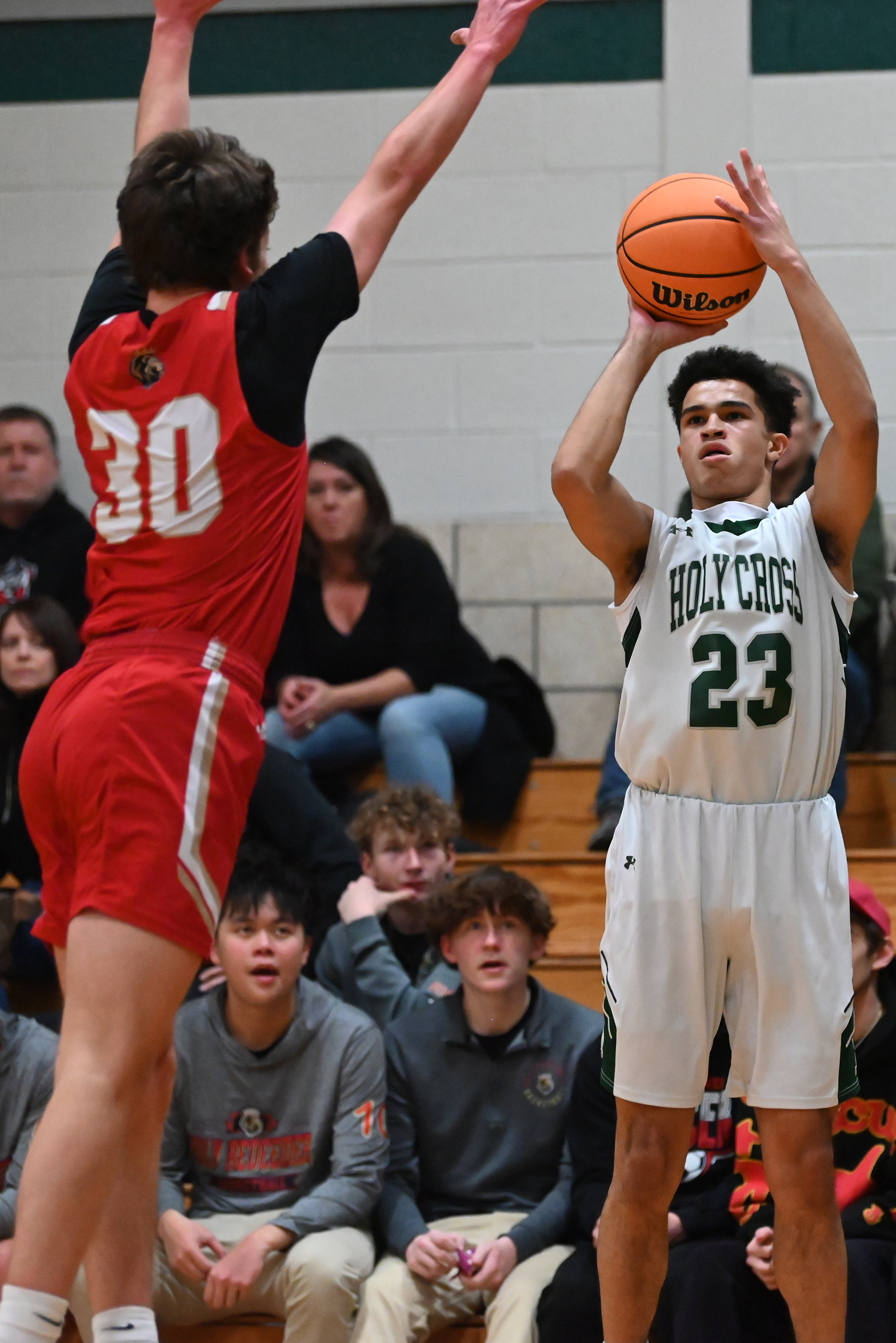 Holy Redeemer’s Charlie Schaffer blocks Holy Cross’ CJ Thompson shot...